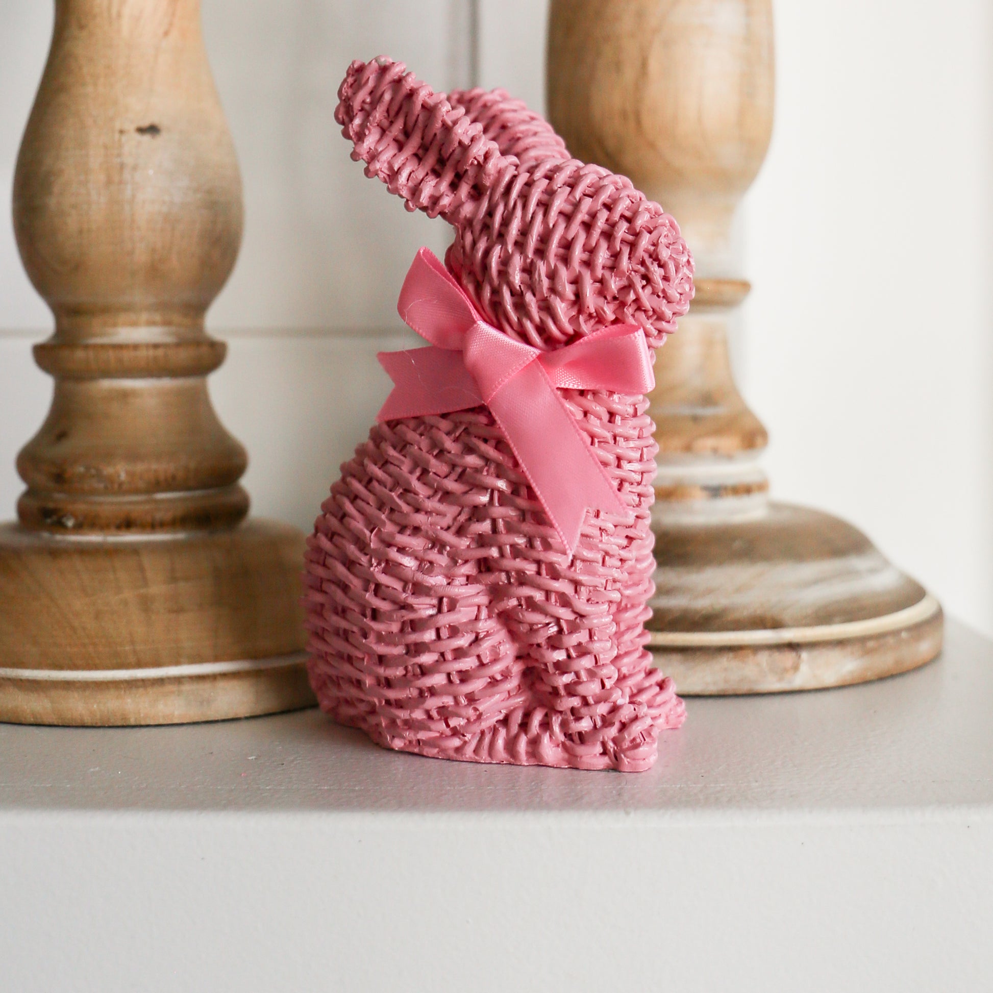 Pink Woven Wicker Bunny with Bow Standing by Staircase